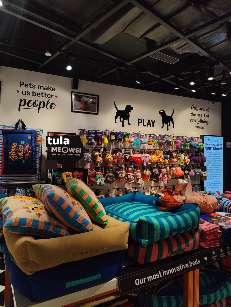 Stacked pet beds and cushions on display in a Tula store